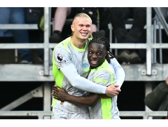 Manchester City's Norwegian striker #09 Erling Haaland (L) celebrates scoring the team's first goal during the English Premier League football match between Burnley and Manchester City at Turf Moor in Burnley, north-west England on April 22, 2026. (Photo by Paul ELLIS / AFP)