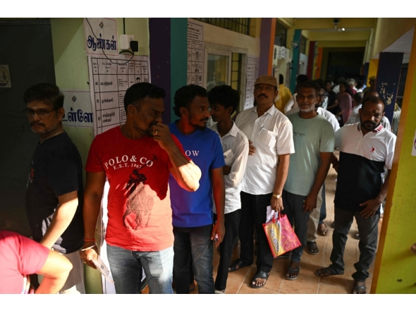 Voters queue to cast their vote outside a polling station during the 2026 Tamil Nadu Legislative Assembly elections in Chennai on April 23, 2026. (Photo by R.Satish BABU / AFP)
