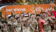 Al Rayyan players celebrate with the trophy after beating Al Shabab in the final.