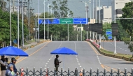 Security personnel stands guard at a closed road leading to the Serena Hotel in the Red Zone area of Islamabad on April 23, 2026. (Photo by Asif Hassan / AFP)
 