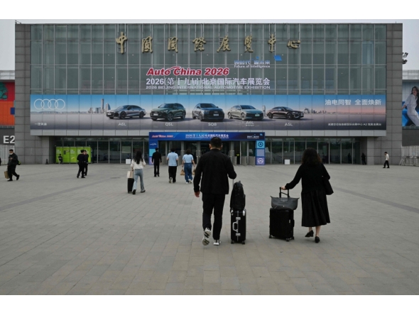 People visit the Beijing Auto Show on its opening day in Beijing on April 24, 2026. (Photo by Adek Berry / AFP)