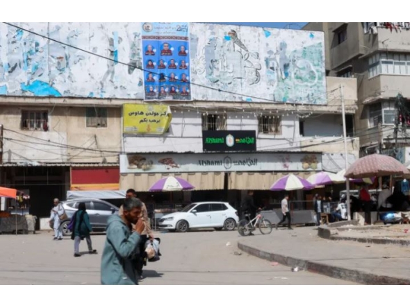 A poster of electoral candidates in Deir el-Balah in Gaza. Photo by Haseeb Alwazeer/Reuters