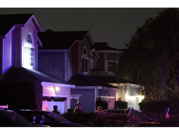 FBI tactical agents leave a house associated with the suspected White House Correspondents’ Dinner shooter after making entry at the residence in Torrance, California, late on April 25, 2026. Photo by Patrick T. Fallon / AFP