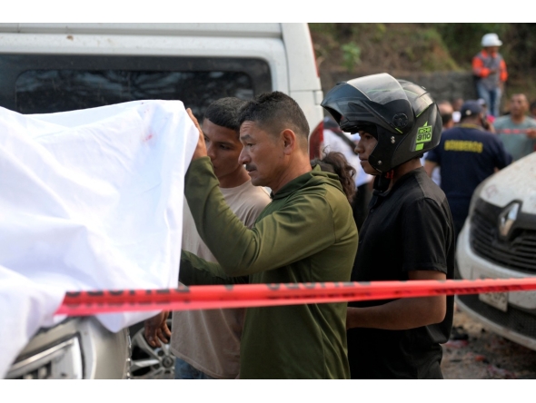 Relatives identify one of the victims after a bomb attack at El Tunel, on the Popayan-Cali road, in Cajibio, Cauca department, Colombia, on April 25, 2026. (Photo by Joaquin SARMIENTO / AFP)