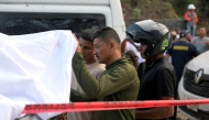 Relatives identify one of the victims after a bomb attack at El Tunel, on the Popayan-Cali road, in Cajibio, Cauca department, Colombia, on April 25, 2026. (Photo by Joaquin SARMIENTO / AFP)
