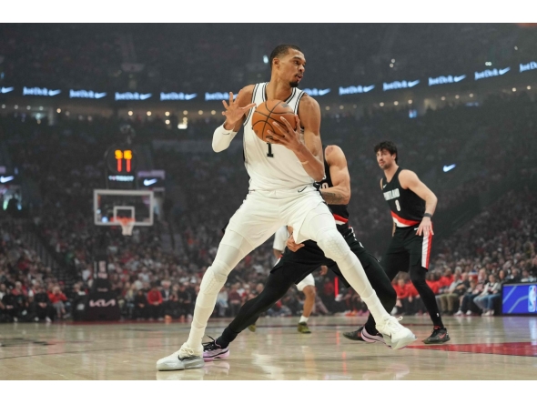 Victor Wembanyama #1 of the San Antonio Spurs posts up against Toumani Camara #33 of the Portland Trail Blazers during the first half of Game Four of the Western Conference First Round Playoffs at Moda Center on April 26, 2026 in Portland, Oregon. (Photo by Soobum Im / GETTY IMAGES NORTH AMERICA / Getty Images via AFP)