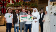 Head of Operations Balu Subramanion, COO Vyanktesh Jaiswal, Tawar Mall MD Yacoub Boutros, and MD Sajed Jassim Mohammed Sulaiman, joined by his family, present the award to the winner.