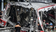 INDONESIA-RAIL-ACCIDENT
Workers clear debris at the train collision site after the locomotive of a passenger train pierced through the rear car of a commuter train at Bekasi Timur Station in Bekasi, West Java on April 28, 2026. 
(Photo by Rezas / AFP)