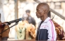 Christopher Okello Onyum, suspected in the killing of four toddlers at a daycare in Ggaba, stands in the dock during his trial at the Ggaba Community Church Grounds in Kampala on April 13, 2026. Photo by Stuart Tibaweswa / AFP