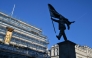 A statue (R) which suddenly appeared the day before, bearing the signature of British street artist Banksy etched onto its base, is pictured in Waterloo Place in central London early morning on April 30, 2026. Photo by Richard A. Brooks / AFP