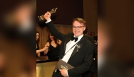 Russian teacher Pavel Talankin hoists his Oscar for Best Documentary Feature Film for 