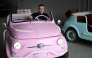 Owner of the Officine Gentile garage, Giovanni Gentile sits at the wheel of a model of a Fiat 500 Jolly Lido at his workshop in Turin on April 30, 2026. (Photo by Marco Bertorello / AFP)