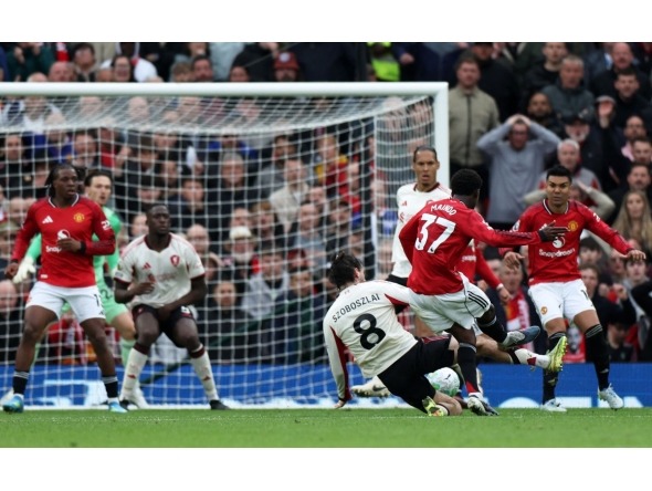 Manchester United's English midfielder #37 Kobbie Mainoo scores the team's third goal during the English Premier League football match between Manchester United and Liverpool at Old Trafford in Manchester, north west England, on May 3, 2026. (Photo by Darren Staples / AFP)