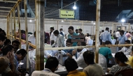 Election officials count votes after the West Bengal Legislative Assembly elections at the Netaji Indoor Stadium in Kolkata on May 4, 2026. 
 (Photo by Dibyangshu SARKAR / AFP)