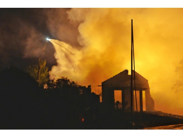 Firefighters spray water at the scene of a fireworks factory explosion in Liuyang, in China痴 central Hunan province early on May 5, 2026. (Photo by CNS / AFP) 