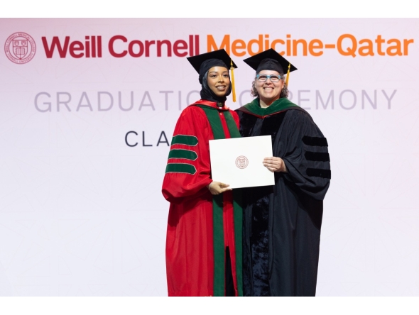 Dr. Moune Jabre presents class valedictorian Dr. Lina Ahmed with her diploma. 