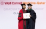 Dr. Moune Jabre presents class valedictorian Dr. Lina Ahmed with her diploma. 
