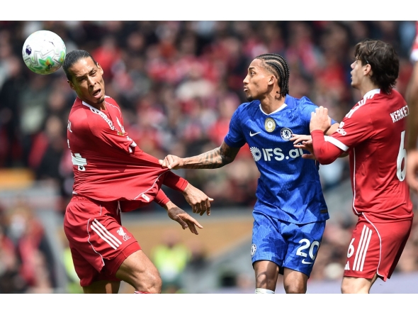 Chelsea's Brazilian striker #20 Joao Pedro pulls on the shirt of Liverpool's Dutch defender #04 Virgil van Dijk during the English Premier League football match between Liverpool and Chelsea at Anfield in Liverpool, north west England on May 9, 2026. (Photo by PETER POWELL / AFP)