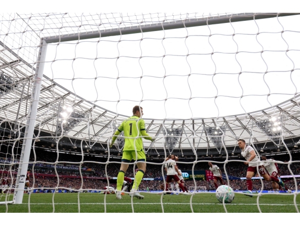 Arsenal's Belgian midfielder Leandro Trossard celebrates scoring the team's first goal past West Ham United's Danish goalkeeper Mads Hermansen during the English Premier League football match between West Ham United and Arsenal at the London Stadium, in east London on May 10, 2026. (Photo by Adrian Dennis / AFP