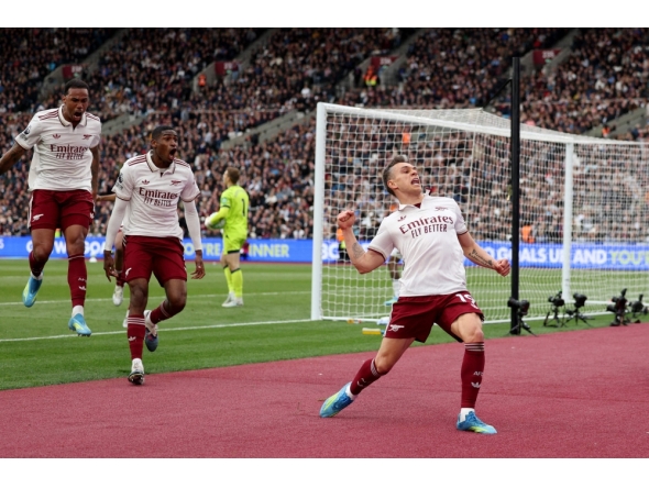 Arsenal's Belgian midfielder Leandro Trossard celebrates scoring the team's first goal during the English Premier League football match between West Ham United and Arsenal at the London Stadium, in east London on May 10, 2026. (Photo by Adrian Dennis / AFP) /