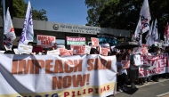 Protesters holding banners protest in support of the impeachment of Philippine Vice-President Sara Duterte in front of the House of Representatives in Quezon City, Metro Manila  (Photo by Ted  Aljibe / AFP)