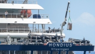 The Dutch flagged hantavirus-stricken cruise ship MV Hondius receives provisions from a boat in the port of Granadilla de Abona on the island of Tenerife in Spain's Canary Islands on May 11, 2026. Photo by JORGE GUERRERO / AFP