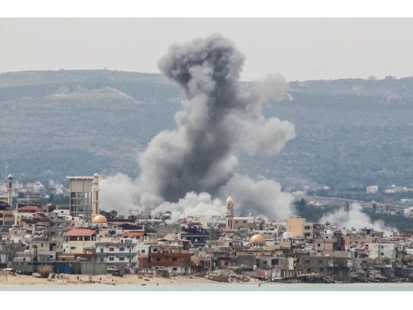  A photograph taken from the southern area of Tyre shows smoke rising from the site of an Israeli airstrike that targeted the area of Ras Al-Ain on May 12, 2026. (Photo by KAWNAT HAJU / AFP)
