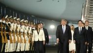 US President Donald Trump (C) is escorted by China's Vice President Han Zheng (R) upon his arrival at Beijing Capital Airport in Beijing on May 13, 2026. (Photo by Brendan Smialowski / AFP)