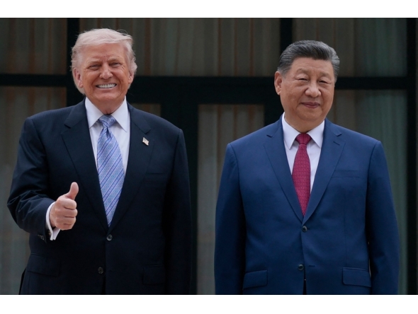 US President Donald Trump (L) poses for photos with China's President Xi Jinping during a visit to Zhongnanhai Garden in Beijing on May 15, 2026. (Photo by Evan Vucci / POOL / AFP)