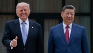 US President Donald Trump (L) poses for photos with China's President Xi Jinping during a visit to Zhongnanhai Garden in Beijing on May 15, 2026. (Photo by Evan Vucci / POOL / AFP)