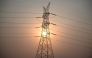 (Files) This file photo taken on April 16, 2026 shows the sun setting next to power lines along San Fernando town, Pampanga province, north of Manila. (Photo by Ted Aljibe / AFP)