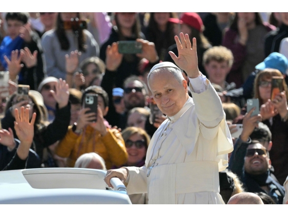 Pope Leo XIV waves to the crowd during the weekly general audience at St Peter's Square in The Vatican on April 8, 2026. Photo by Tiziana FABI / AFP