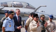 Indonesian President Prabowo Subianto (front) delivers a statement to journalists during a ceremony to hand over six new Rafale jet fighters, four Dassault Falcon 8X aircrafts and one Airbus A400M Atlas aircraft to the Indonesian Air Force at Halim Perdanakusuma Air Force Base in Jakarta.. (Photo by Bay Ismoyo / AFP)
