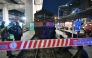 (Files) Officials stand next to the front of a train that collided with a bus underneath Makkasan Airport Rail station in Bangkok on May 16, 2026. (Photo by Lillian Suwanrumpha / AFP)
 