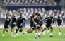 Qatar players take part in a training session. RIGHT: Coach Julen Lopetegui reacts during the session.