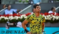 (FILES) Spain's Carlos Alcaraz reacts during his 2023 ATP Tour Madrid Open tennis tournament singles match against Finland's Emil Ruusuvuori at the Caja Magica in Madrid on April 28, 2023. Carlos Alcaraz announced his withdrawing from Wimbledon, AFP reports on May 19, 2026. (Photo by JAVIER SORIANO / AFP)
