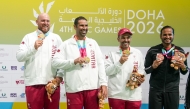 Qatar's Angelo Scalzoni, Mohammed Al Rumaihi and Saeed Abu Shareb celebrate with their gold medals.