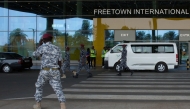 Security escort migrants in a National Public Health Agency (NPHA) after their arrival at Freetown International Airport, formerly known as Lungi International Airport, in Lungi on May 20, 2026. (Photo by AFP)