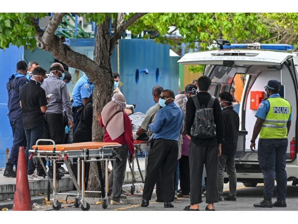 Red Crescent emergency responders and police personnel transfer the bodies of Italian tourists from a police speed boat to an ambulance in Male on May 19, 2026. Photo by MOHAMED AFRAH / AFP