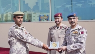 Chief of Staff of the Qatari Armed Forces H E Lieutenant General (Pilot) Jassim bin Mohammed Al Mannai and  Amiri Guard Commander H E Major General Staff Mohammed bin Sultan Al Suwaidi with a graduate during the ceremony. 
