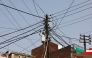 A worker repairs a street light in Varanasi on May 22, 2026. (Photo by Niharika KULKARNI / AFP)