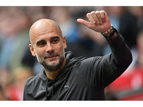 (FILES) Manchester City's Spanish manager Pep Guardiola waves to the fans ahead of the English FA Cup semi-final football match between Manchester City and Sheffield United at Wembley Stadium in north west London on April 22, 2023. (Photo by Glyn KIRK / AFP)