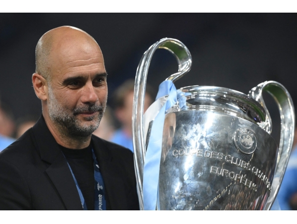 (Files) Manchester City's Spanish manager Pep Guardiola celebrates with the European Cup trophy on June 10, 2023. (Photo by Franck Fife / AFP)
 
