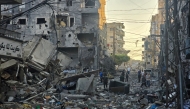 People inspect the site of an Israeli strike in the southern Lebanese coastal city of Tyre on May 23, 2026. (Photo by Kawnat Haju/ AFP)