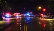 Police vehicles and tape blocks off a crime scene near the White House after a gunman opened fire in Washington, DC, on May 23, 2026. (Photo by Alex Wroblewski / AFP)
