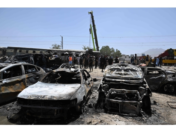 A crane lifts a carriage of a train at the site after an explosion that targeted a train in Quetta on May 24, 2026. (Photo by Banaras Khan / AFP)