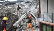 Rescuers remove metal rubbles as they search for survivors on a collapsed building in Angeles City, Pampanga province, north of Manila on May 24, 2026. Nineteen people are feared trapped after a building under construction near Manila collapsed early on May 24, a local government official said. (Photo by Ted ALJIBE / AFP)