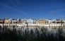 A picture taken on April 30, 2026 shows residential buildings alongside the Guadalquivir river on Betis street in Seville. Photo by CRISTINA QUICLER / AFP