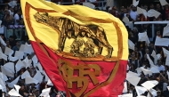 Roma's supporters wave a giant flag ahead of the Italian Serie A football match between Roma and Lazio at Olympic stadium in Rome on May 17, 2026. (Photo by Isabella BONOTTO / AFP)
