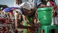 Parishioners wash their hands before entering the church following local authorities’ instructions to limit the spread of the Ebola outbreak in eastern Democratic Republic of the Congo in Bunia on May 24, 2026. (Photo by Seros Muyisa / AFP)